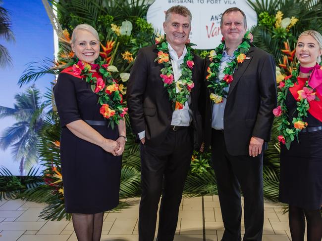 Qantas cabin crew Kimmy Jones and Lauren Clarkson, with Qantas International CEO Cam Wallace and Brisbane Airport Corporation CEO Gert-Jan de Graaff.