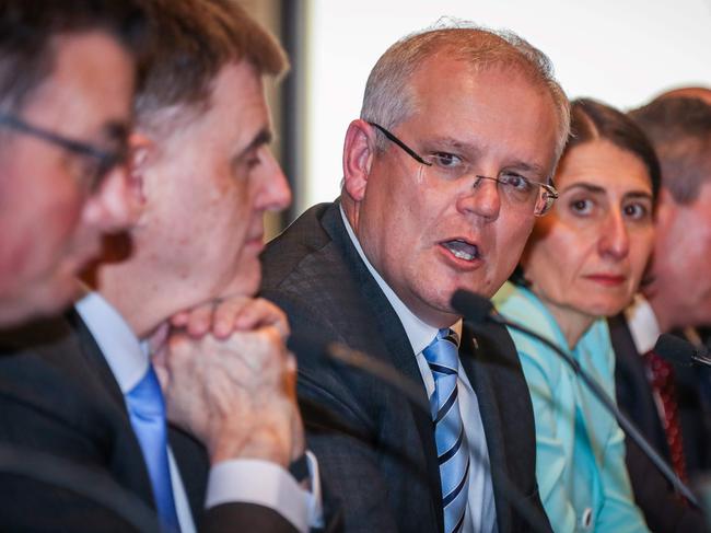 Australian Prime Minister Scott Morrison (C) speaks as he sits with Australian state Premiers and territory leaders during a media conference after the Meeting of the Council of Australian Governments (COAG) at Parramatta Stadium, in western Sydney on March 13, 2020. (Photo by DAVID GRAY / AFP)