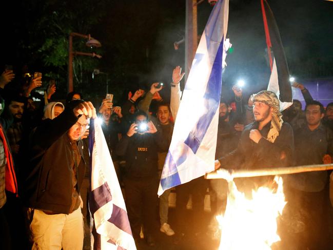 Iranian students and demonstrators burn Israeli flags as they protest in support of Palestinians in front of the British embassy in Tehran. Picture: AFP