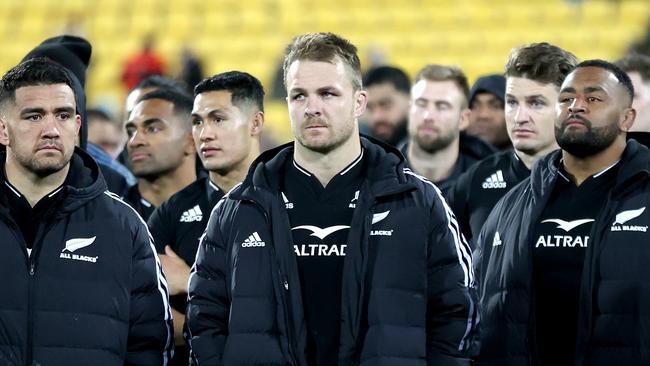 Sam Cane leads a dejected All Blacks outfit off the pitch after loss to Ireland.