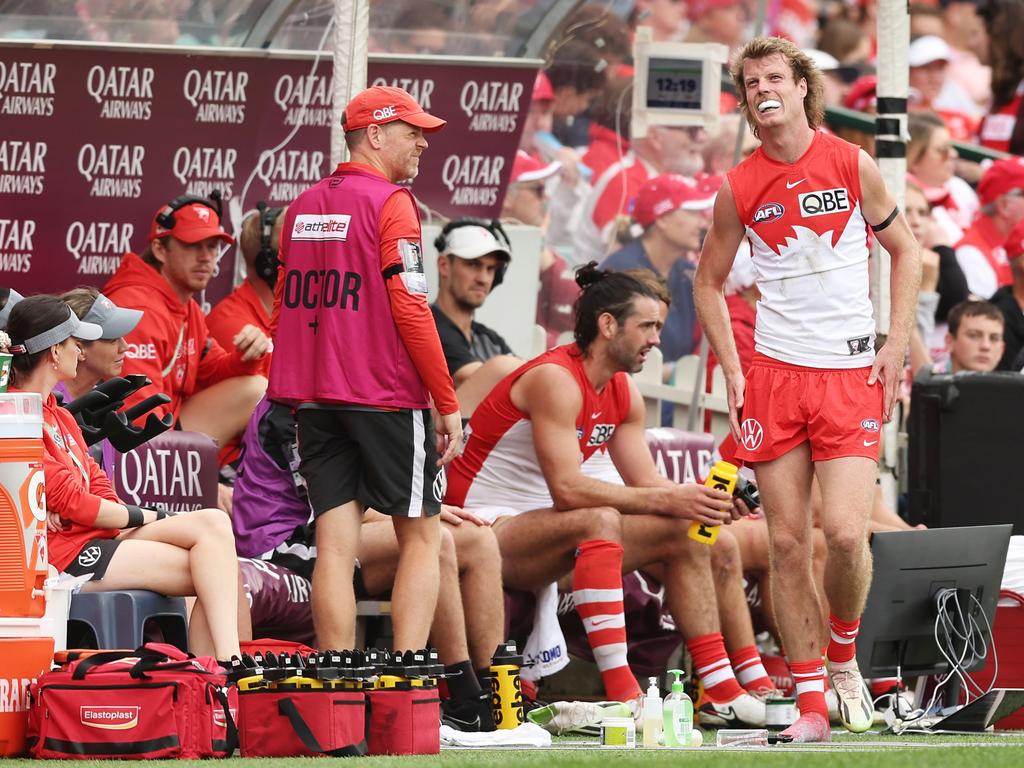 Nick Blakey of the Swans shows discomfort on the bench. Picture: Matt King/AFL Photos/via Getty Images.