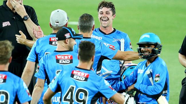 Travis Head is congratulated by his teammates after guiding the Adelaide Strikers to a thrilling New Year’s Eve win against Sydney Sixers at Adelaide Oval last year. Picture: Sarah Reed