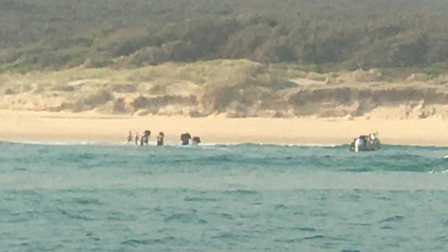 The group of hikers are rescued by Bryan Hartas and Dale Winward after starting the Wingan Inlet-Mallacoota walk.