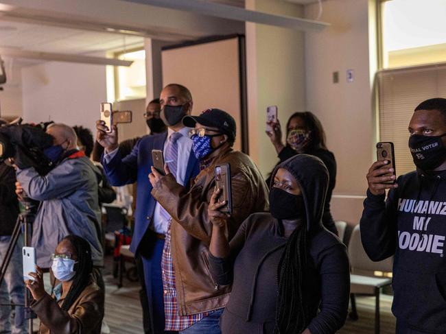 Community members watch body footage cam at the Brooklyn Centre Police Station after a police officer shot and killed a Black man. Picture: AFP