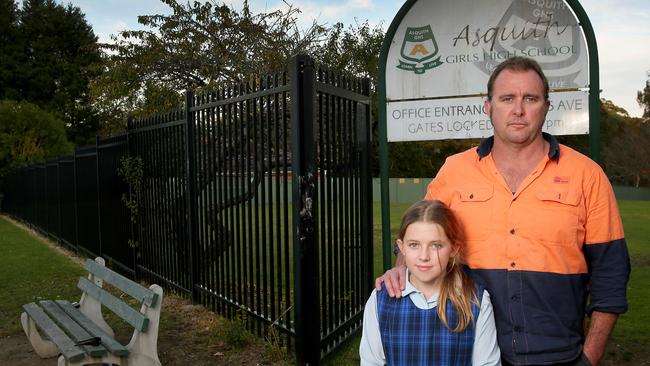 There is a growing push to see Asquith Girls and Asquith boys amalgamated into a co-education senior and junior schools. Tabitha Woodford with Father Luke. Picture: Adam Ward