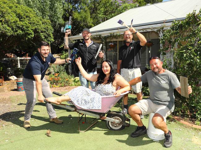 Janelle Bridges with the tradies who helped re-build her house for free from left Mus Erkul Geelong territory manager for Dulux Trade, Anthony Axon director of Axon Plastering, Colin Reid owner of CJ Reid Painting and Charlie Debono from CharlieÃs Mowing and Maintenance. Picture: Alison Wynd