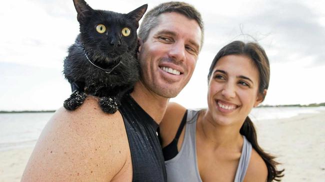 SWIMMING STAR: Nathan the swimming cat with owners Rian Crandon and Melissa Pietrobuono.