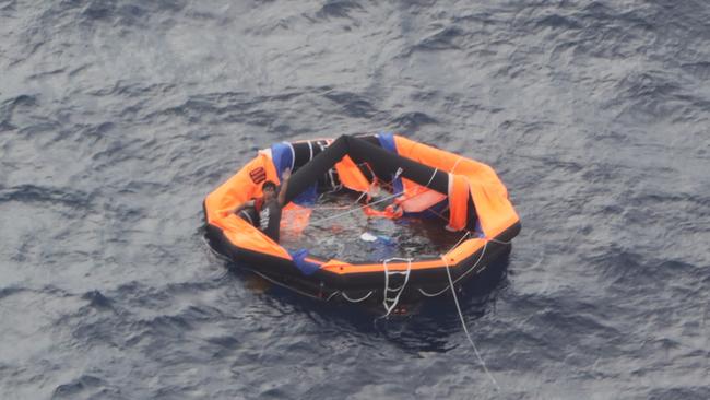 A 30-year-old Philippine national, the second survivor, of the capsized cattle ship Gulf Livestock 1 is seen on a life raft on September 4 in Amamioshima, Japan. (Photo by Japan Coast Guard, 10th Regional Coast Guard Headquarters via Getty Images)