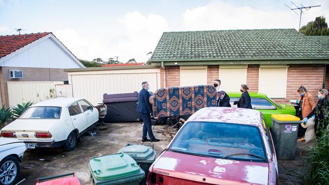 Major Crime detectives recover a couch from the home on Mander Road at Christie Downs.Picture: Tom Huntley