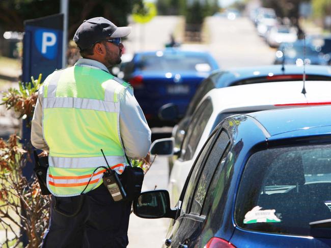 A file photo of a Waverley Council Parking Ranger issuing fines.