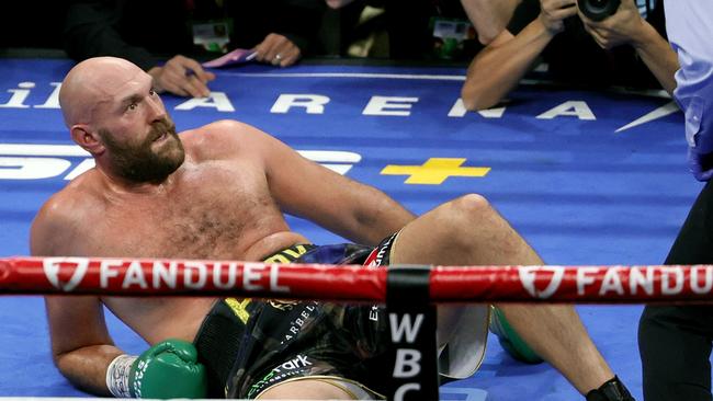 LAS VEGAS, NEVADA - OCTOBER 09: Tyson Fury reacts after he was knocked down by Deontay Wilder in the fourth round of their WBC heavyweight title fight at T-Mobile Arena on October 9, 2021 in Las Vegas, Nevada. Fury retained his title with an 11th-round knockout. Fury retained his title with an 11th-round knockout. Ethan Miller/Getty Images/AFP == FOR NEWSPAPERS, INTERNET, TELCOS &amp; TELEVISION USE ONLY ==