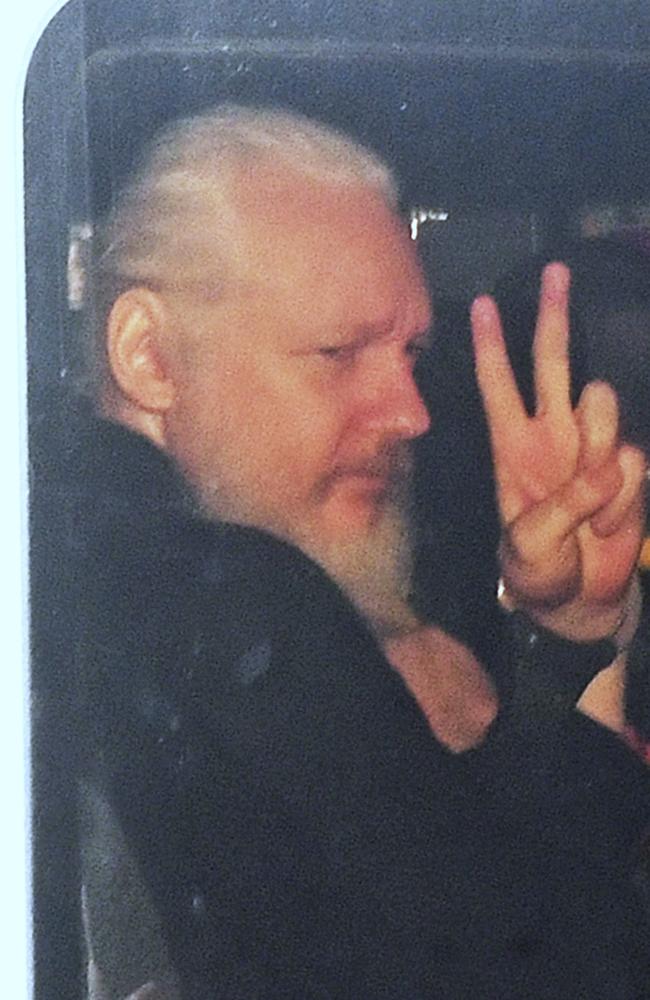 Julian Assange gestures as he arrives at Westminster Magistrates' Court in London, after the WikiLeaks founder was arrested by officers from the Metropolitan Police. Picture: AP