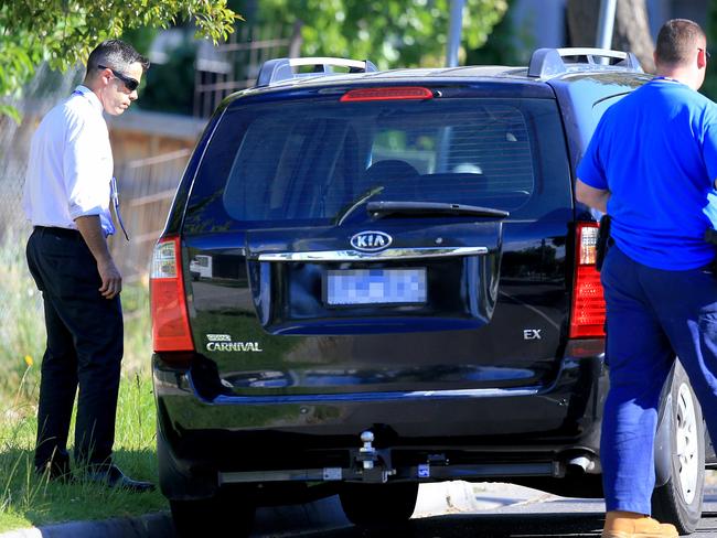 Police focus on a black Kia Carnival van. Picture: Mark Stewart