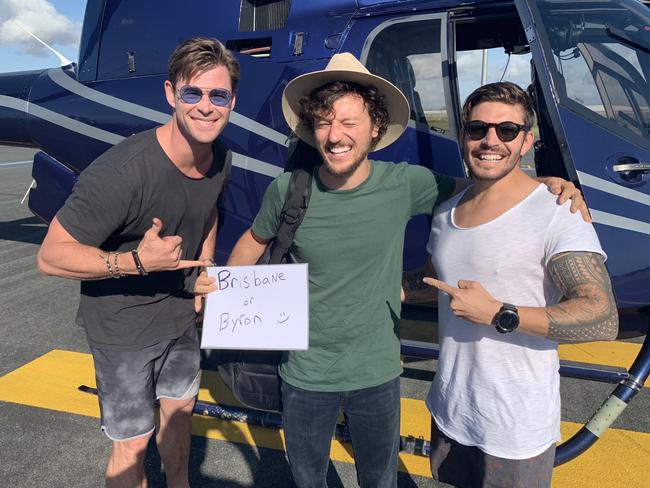 Chris Hemsworth (left) and Luke Zocchi (right) transported hitchhiker Scott Hildebrand from Brisbane to Byron Bay via an Avmin Air Charter private helicopter. Picture: Avmin Air Charter