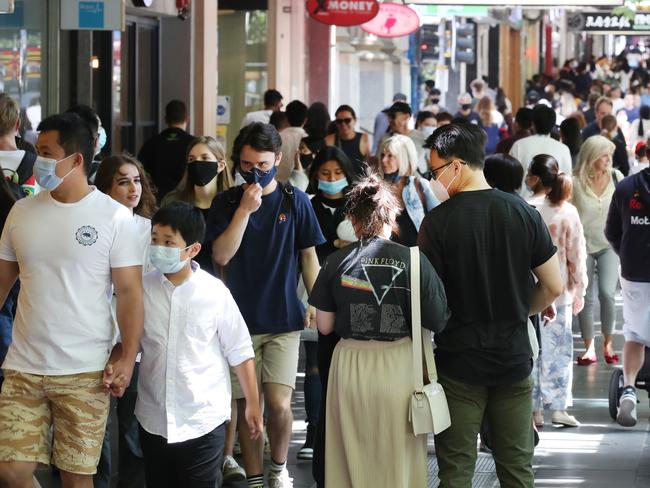 Shoppers in Melbourne CBD for the Boxing Day sales. Face masks are mandatory in large retail stores. Picture: NCA NewsWire/ David Crosling