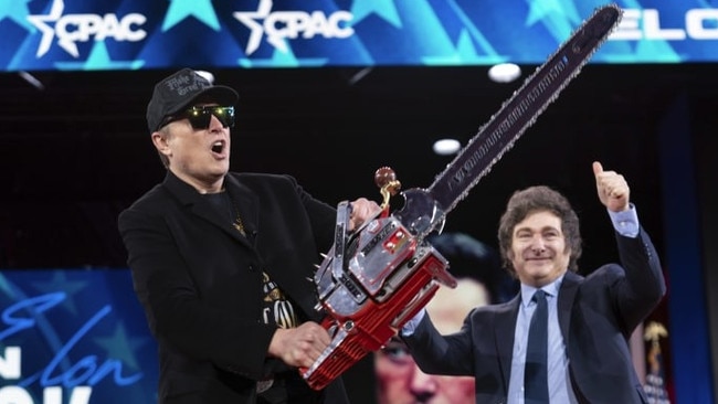 Elon Musk holds up a chainsaw earlier this year at a Washington conference to demonstrate his enthusiasm for cutting the size of government. Picture: Jose Luis Magana/AP