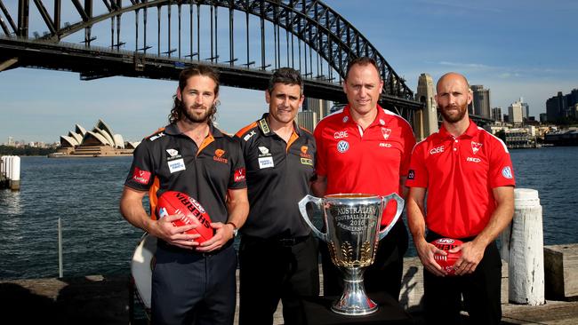 Callan Ward, Leon Cameron, John Longmire and Jarrad McVeigh with the premiership cup in front of the Sydney Harbour Bridge. Picture: Gregg Porteous