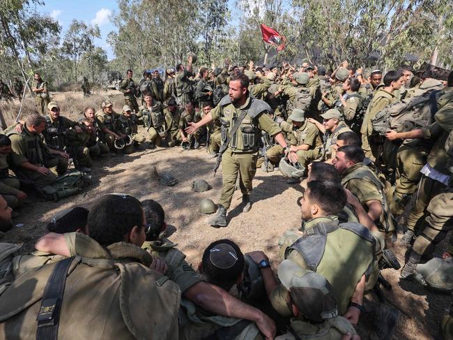 Israeli troops prepare weapons and armed vehicles near the southern city of Ashkelon. Picture: AFP