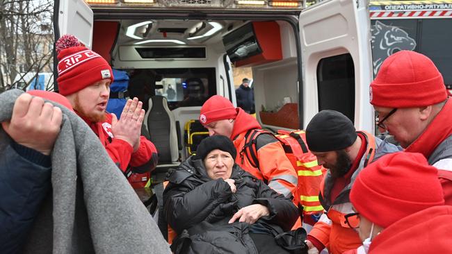 Medical staff carry a woman injured in the missile attack in Kharkiv. Picture: AFP