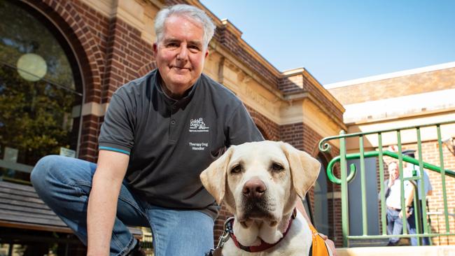 Zara the court therapy dog and her handler Davie Macdonald outside Manly Courthouse where they help calm people before they face the Magistrate or give evidence in court. Picture: AAP Image / Julian Andrews