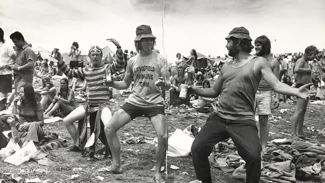 Revellers drink and enjoy the music at Sunbury.