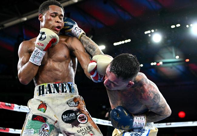 Devin Haney (left) cops one from George Kambosos (Photo by Quinn Rooney/Getty Images)