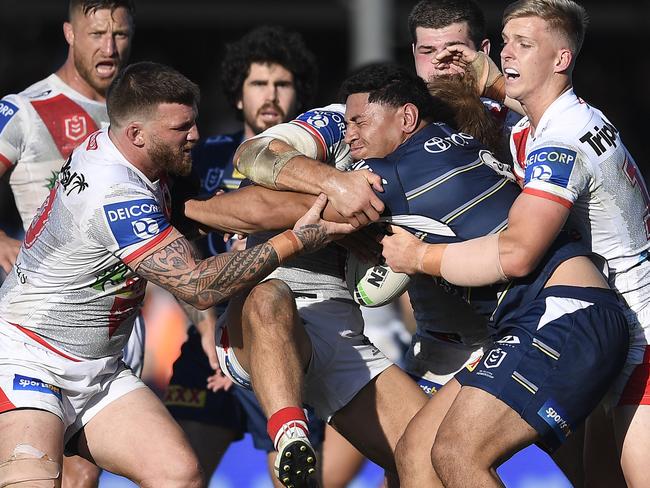 Jason Taumalolo of the Cowboys is wrapped up by the Dragons defence during the round 24 NRL match between the St George Illawarra Dragons and the North Queensland Cowboys at Browne Park. (Photo by Ian Hitchcock/Getty Images)