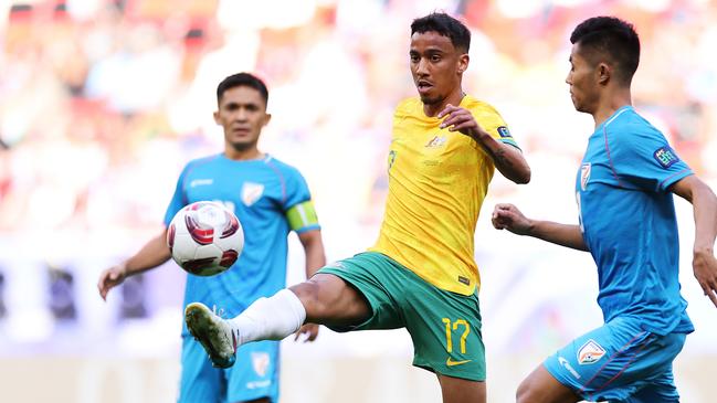 DOHA, QATAR - JANUARY 13: Keanu Baccus of Australia is challenged by Lalengmawia Apuia of India during the AFC Asian Cup Group B match between Australia and India at Ahmad Bin Ali Stadium on January 13, 2024 in Doha, Qatar. (Photo by Robert Cianflone/Getty Images)