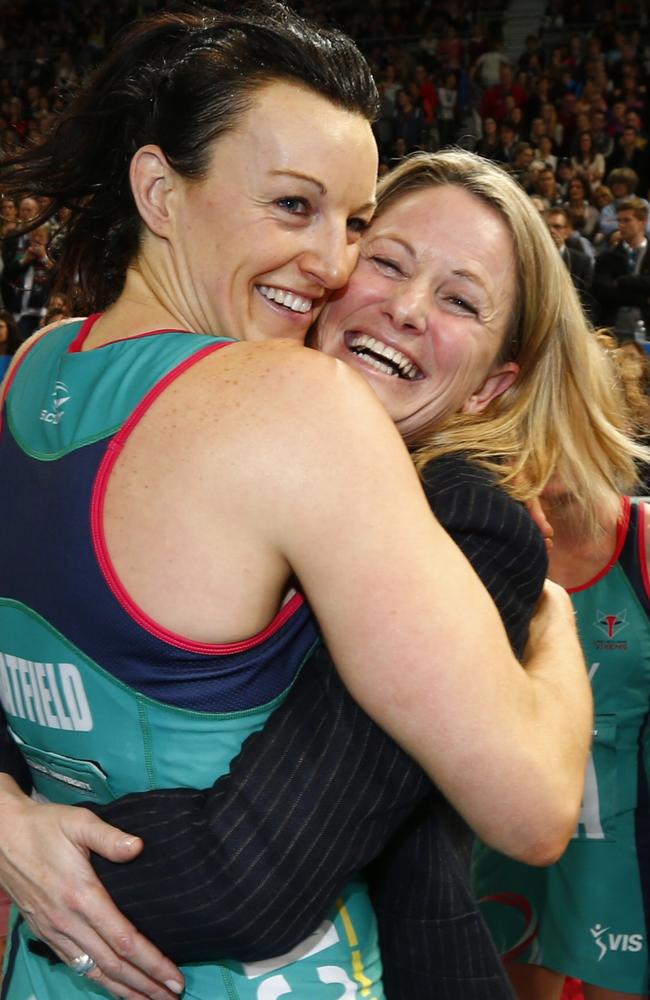 Simone McKinnis embraces Vixens captain Bianca Chatfield after the 2014 premiership win. Pic: Michael Klein
