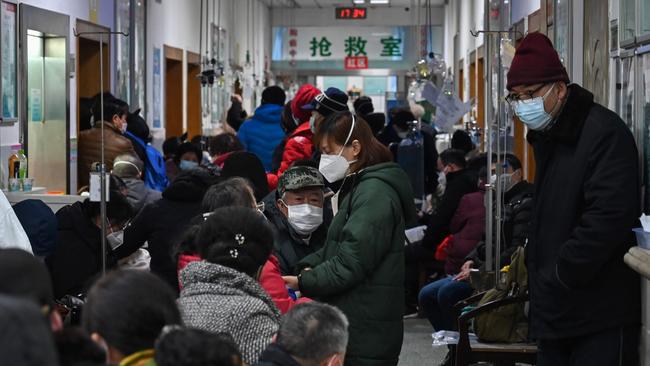 People wearing facemasks await medical attention at Wuhan Red Cross Hospital in Wuhan.