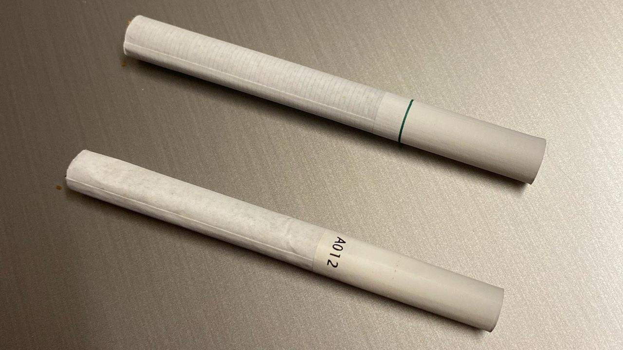One the top is a menthol cigarette bought from the Frenchville Gifts and Tobacconists. The bottom one is from a packet with the legal government branding from another store and has the serial number.