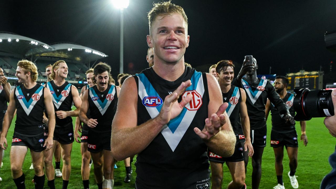 ADELAIDE, AUSTRALIA - APRIL 05: Dan Houston of the Power leads his team off during the round four AFL match between Port Adelaide Power and Essendon Bombers at Adelaide Oval, on April 05, 2024, in Adelaide, Australia. (Photo by Mark Brake/Getty Images)