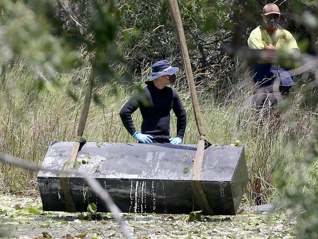 Toolbox murder -  Police retrieve a metal box from a dam near Srubby Creek in Kingston, double murder Logan. Pic Jono Searle.