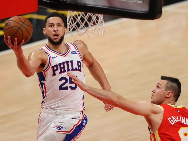 ATLANTA, GEORGIA - JUNE 11:  Ben Simmons #25 of the Philadelphia 76ers drives against Danilo Gallinari #8 of the Atlanta Hawks during the first half of game 3 of the Eastern Conference Semifinals at State Farm Arena on June 11, 2021 in Atlanta, Georgia.  NOTE TO USER: User expressly acknowledges and agrees that, by downloading and or using this photograph, User is consenting to the terms and conditions of the Getty Images License Agreement. (Photo by Kevin C. Cox/Getty Images)