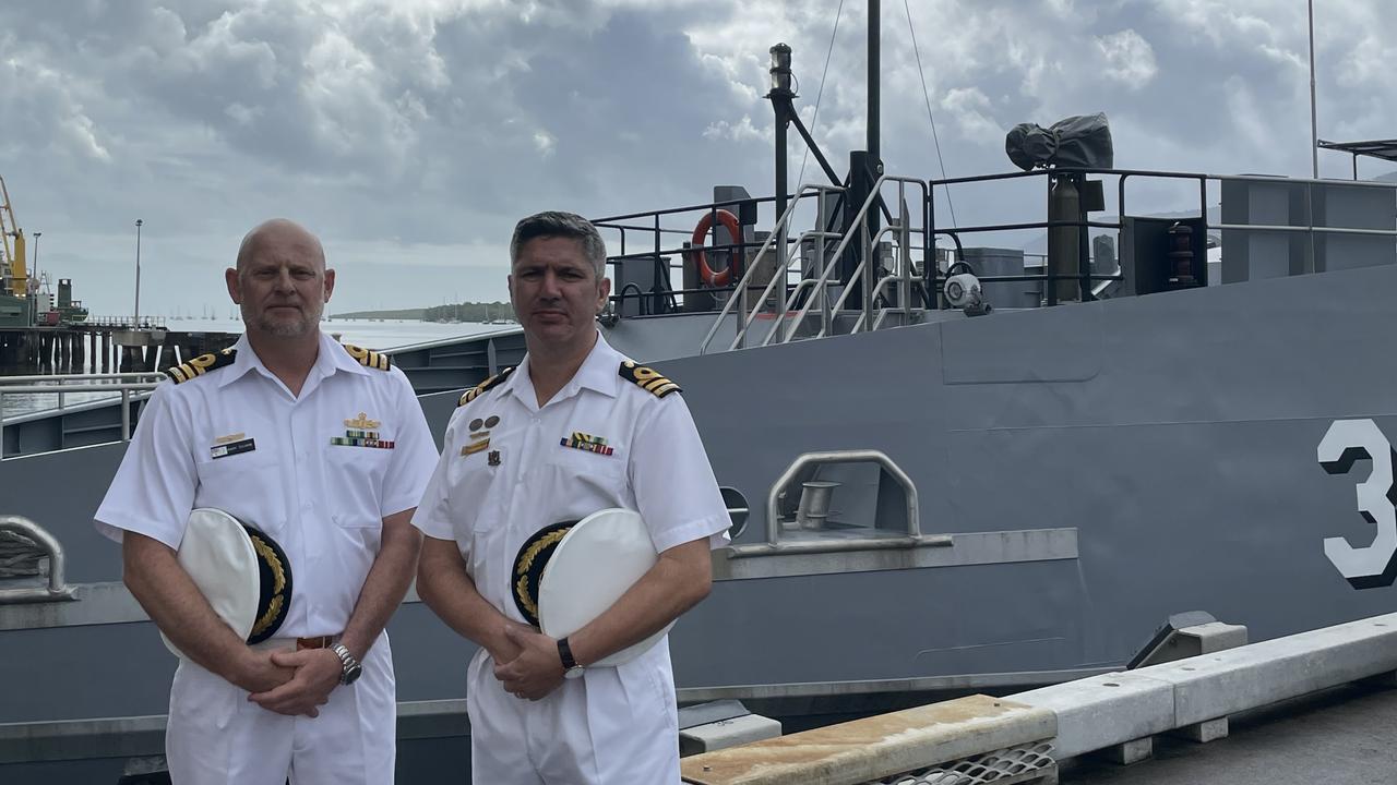 HMAS Cairns new Commanding Officer Andrew Thorpe with outgoing commander Alfonso Santos. Photo: Dylan Nicholson