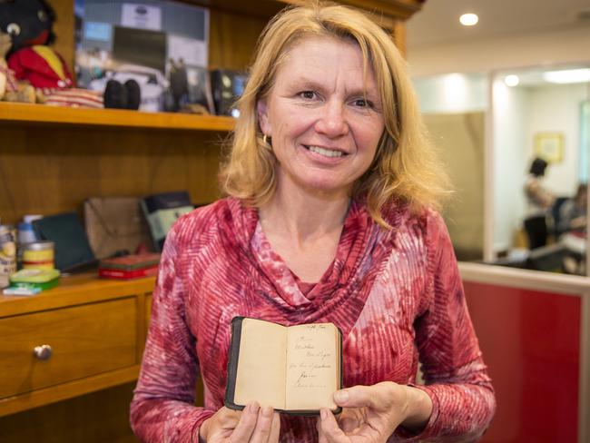 The Green Shed owner Sandie Parkes pictured with the Bible found at the Canberra tip. Picture: Richard Tuffin.