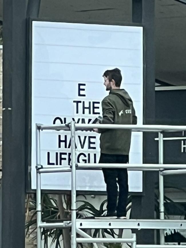 Staff putting up a sign on The Highway Hotel. Picture: Supplied