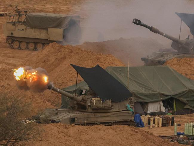 An Israeli army self-propelled artillery howitzer fires rounds from a position near the border with the Gaza Strip in southern Israel. Picture: AFP