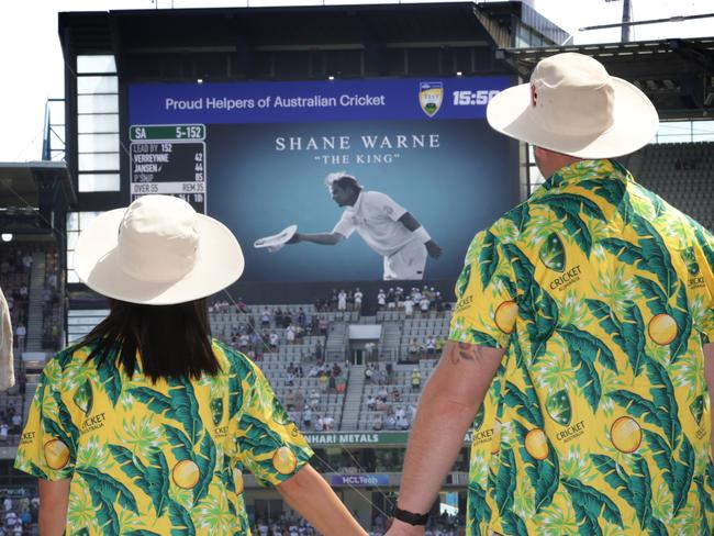 2022 Boxing Day Test MCG. Australia vs South Africa. Crowd colour. Cricket couple Deanna and Blake Averillo who were great fans of Shane Warne, pause and watch his tribute on the big screen.                      Picture: David Caird