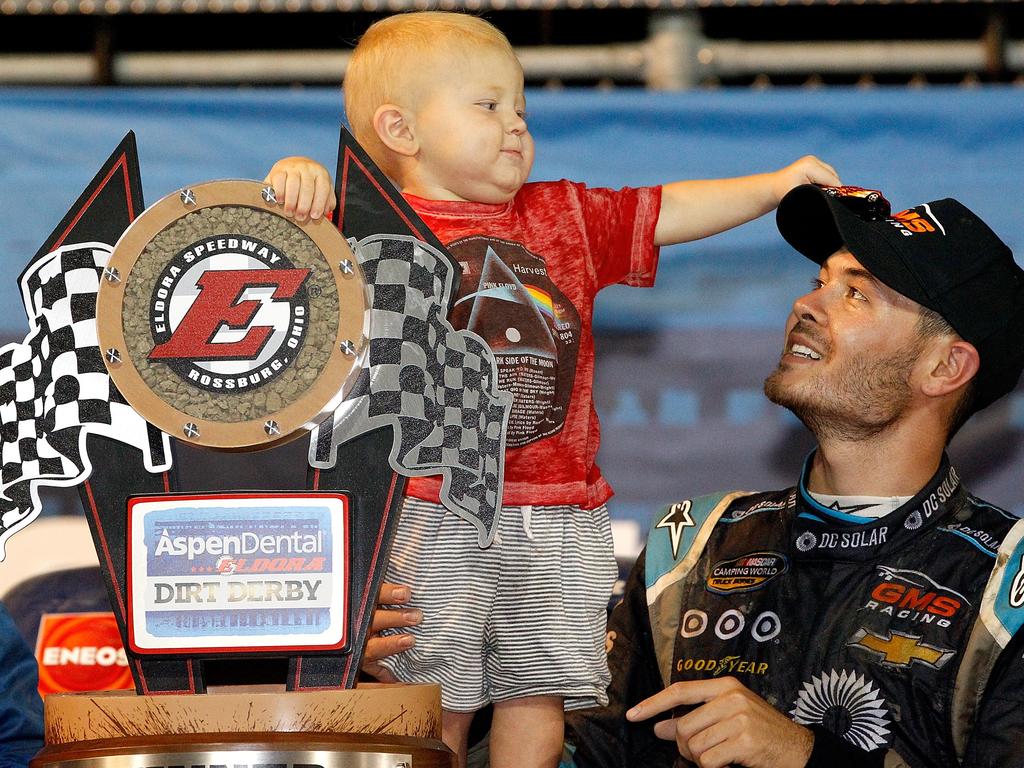 Kyle Larson, driver of the #24 DC Solar Chevrolet, and his son Owen Larson hold the NASCAR Camping World Series 4th Annual Aspen Dental Eldora Dirt Derby 150 trophy after winning at Eldora Speedway on July 20, 2016 in Rossburg, Ohio. Brian Lawdermilk/Getty Images/AFP