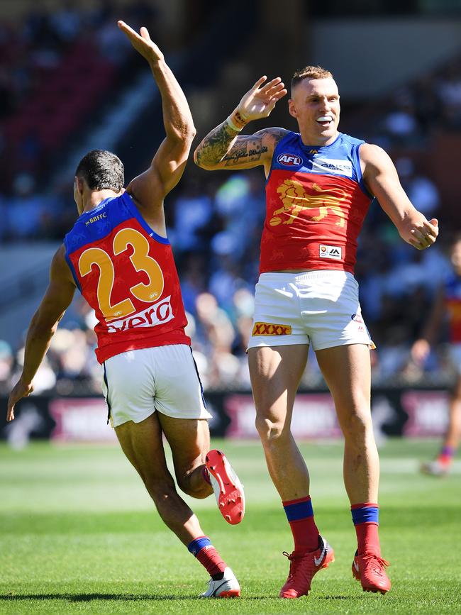 Charlie Cameron and Mitch Robinson celebrate a goal at the Adelaide Oval last season.