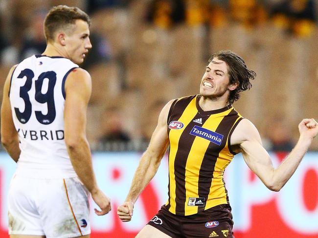 MELBOURNE, AUSTRALIA - JUNE 16: Isaac Smith of the Hawks celebrates a goal against Tom Doedee of the Crows during the round 13 AFL match between the Hawthorn Hawks and the Adelaide Crows at Melbourne Cricket Ground on June 16, 2018 in Melbourne, Australia.  (Photo by Michael Dodge/Getty Images)