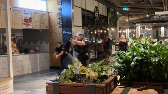 Police engage with an armed active offender inside the shopping mall as part of the simulated training. Picture: Queensland Police Service.