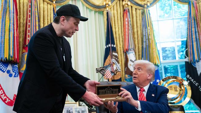 US President Donald Trump gives to Elon Musk a 