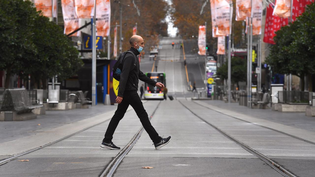 A man crosses Melbourne's usually busy Bourke Street Mall as the city's residents returned to a seven day lockdown to curb the spread of the Covid-19 coronavirus. Photo: William West/AFP)