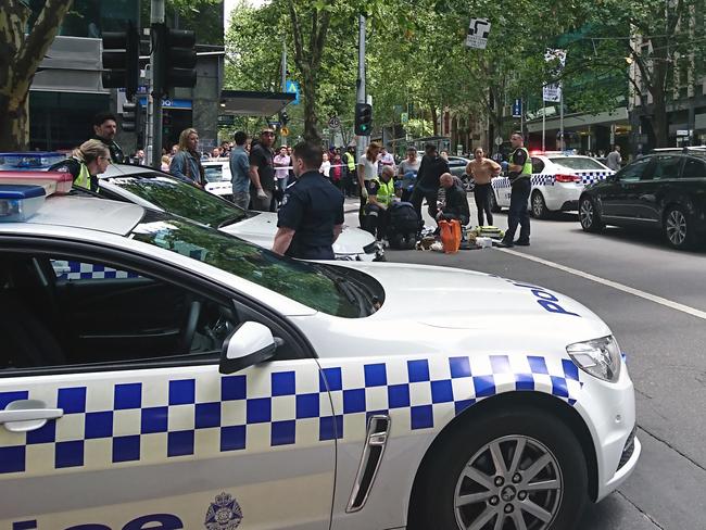 Police and emergency services at the scene after a car hit pedestrians. Picture: AAP/Luke Costin