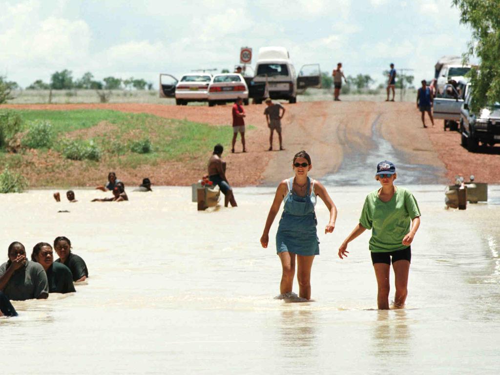 German tourists cross the flooded Barkly Highway at Camooweal in 1999. Picture: Supplied