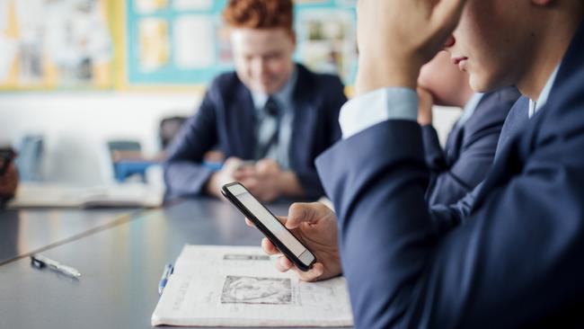 If students can peel themselves away from their devices, adults should take their lead and try doing the same. Picture: News Corp Australia