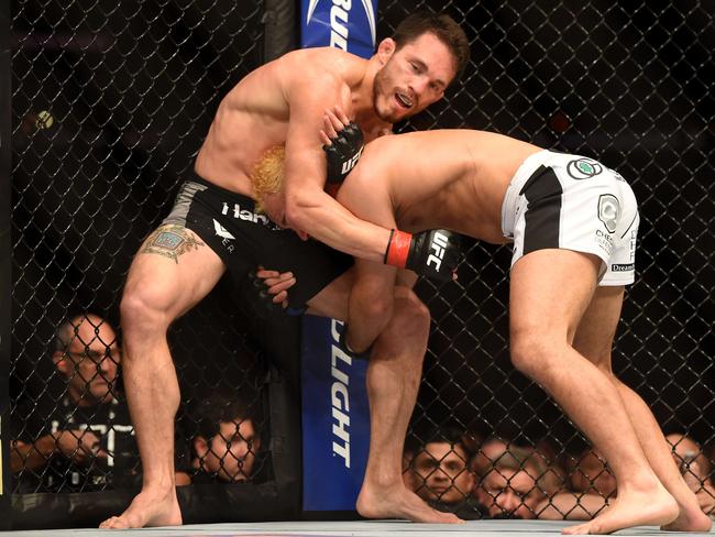 UFC veteran Josh Koscheck (white trunks) attempts to take down Jake Ellenberger.