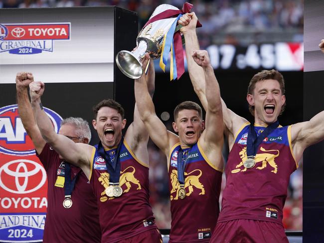 MELBOURNE, AUSTRALIA - SEPTEMBER 28: Chris Fagan, Senior Coach of the Lions, Lachie Neale, Dayne Zorko and Harris Andrews of the Lions celebrate with the 2024 AFL Premiership Cup after winning the AFL Grand Final match between Sydney Swans and Brisbane Lions at Melbourne Cricket Ground, on September 28, 2024, in Melbourne, Australia. (Photo by Daniel Pockett/AFL Photos/Getty Images)